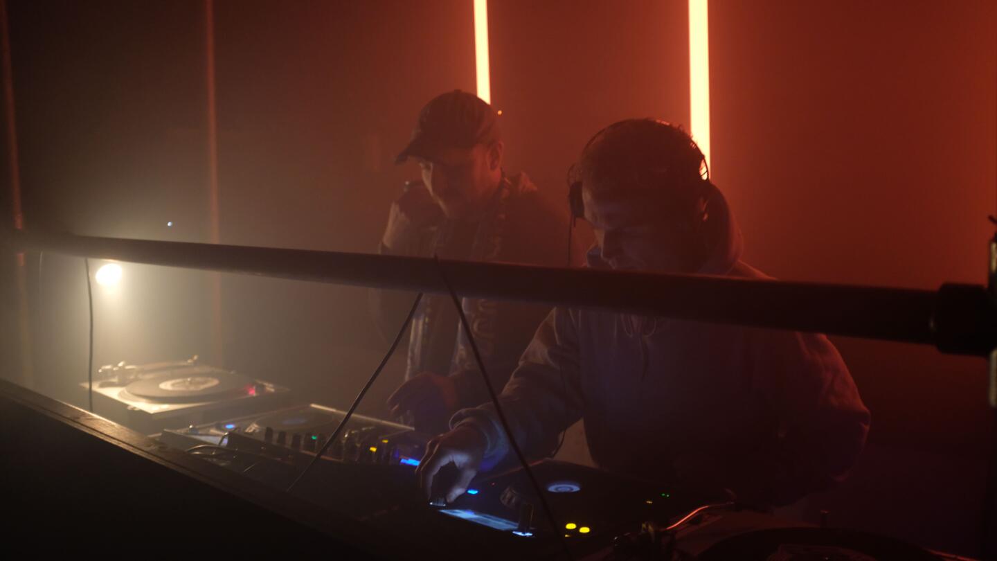 Photo of DJs in a nightclub